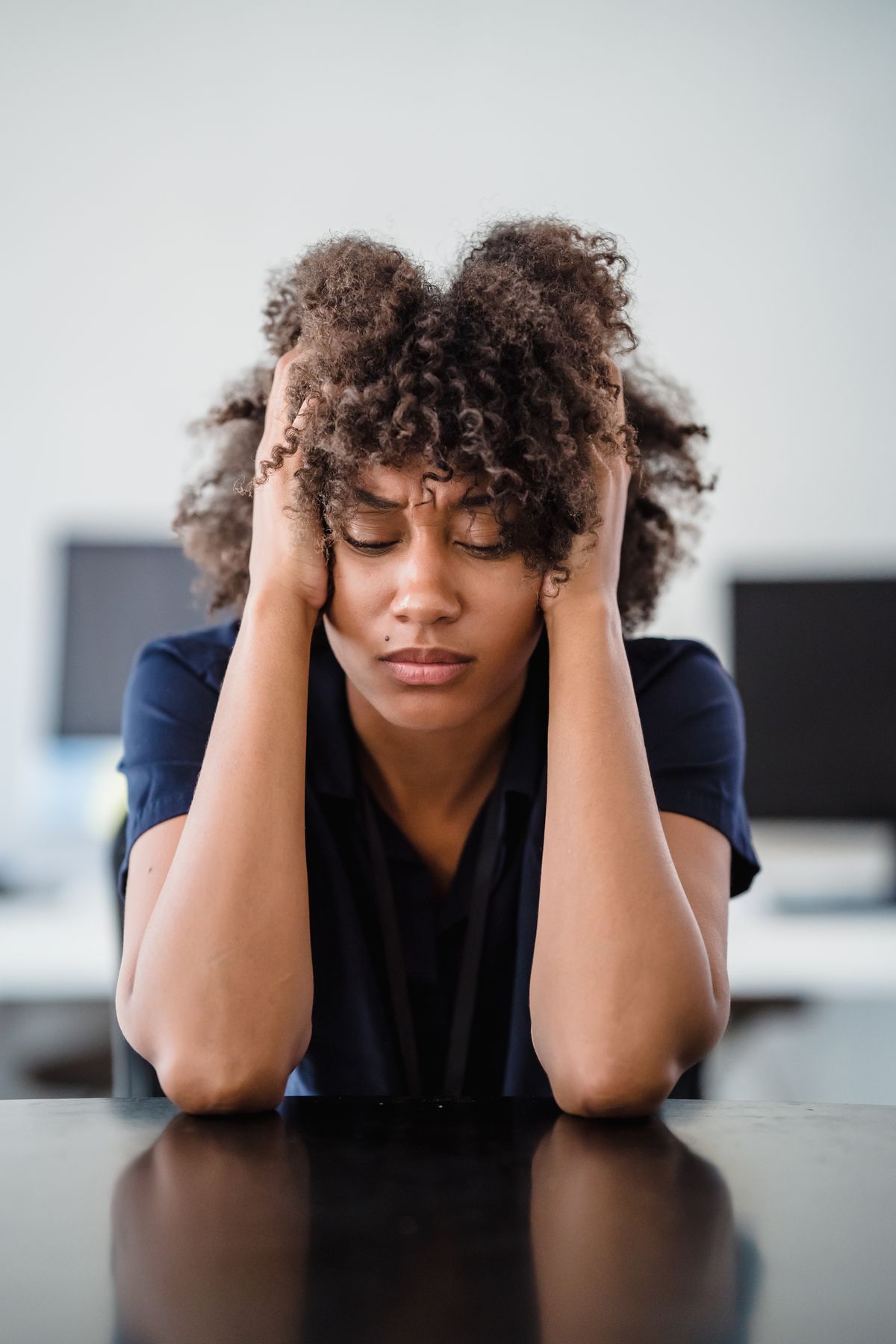Woman holding her head, feeling overwhelmed
